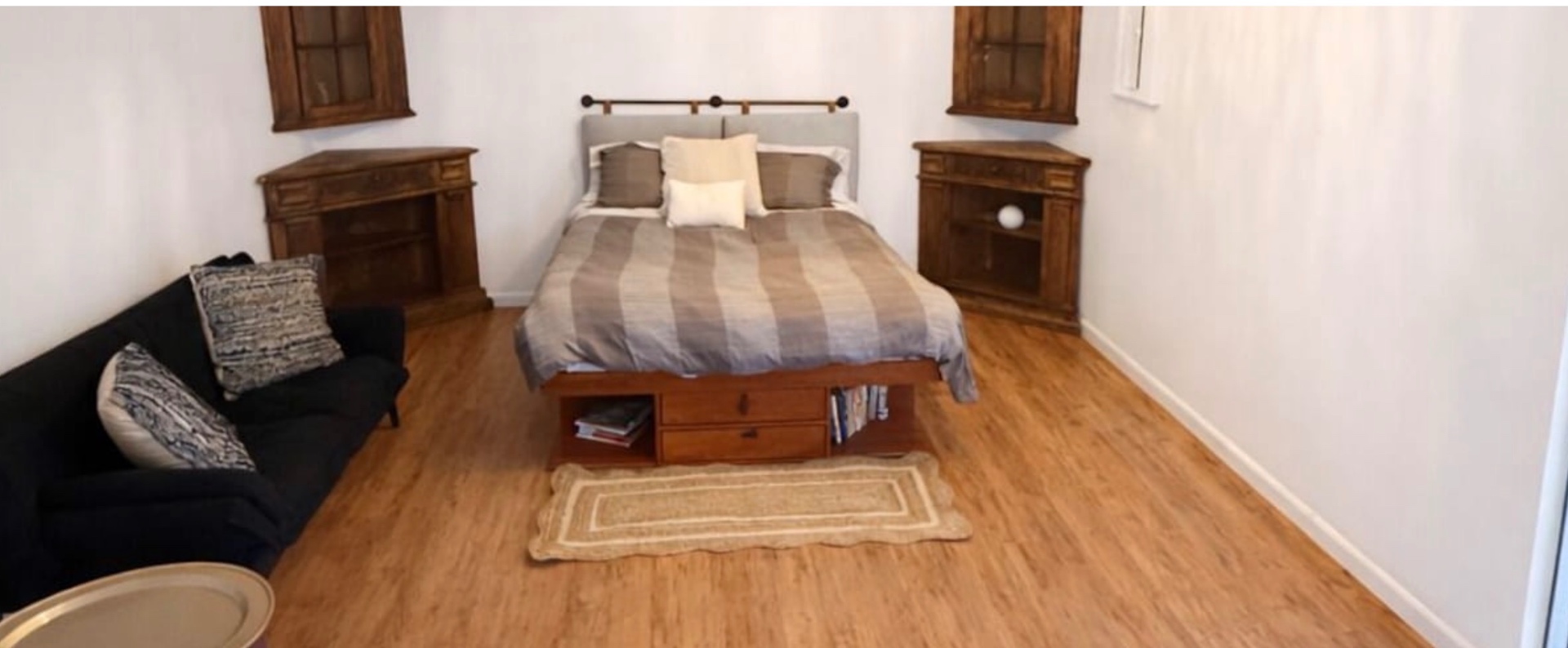 Queen Suite — Spacious bedroom with sitting area and dual nightstands